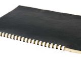 a black notebook with a white strip on top of it