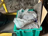 a green box with a bag of garbage in it