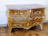 a marble top chest of drawers on display in a room