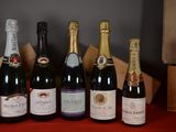 several bottles of wine are lined up on a red table