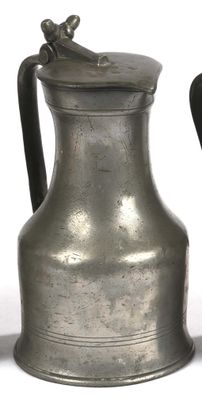 two silver vases sitting next to each other on a table