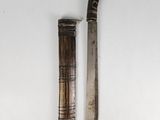 pair of old and worn knifes on a white surface
