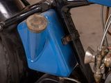 a close up of a motorcycle with a blue box attached to it