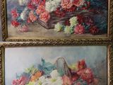 Deux tableaux représentant des fleurs sont accrochés au mur d'une pièce.