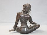 statue of a woman sitting in a lotus position on a white background