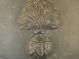 a large metal pot with a tree on it