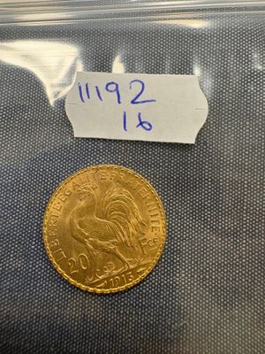 a gold coin in a plastic bag with a label on it