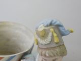 a figurine of a little girl with a hat on her head