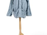 blue shirt and pants on a mannequin stand against a white background