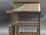a small bird cage with a bird inside of it