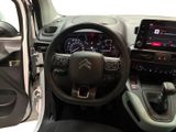 the interior of a small car with a steering wheel and dashboard
