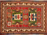 a red and green rug with geometric designs on it