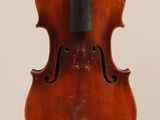 an old violin with a bow hanging from it ' s back