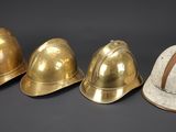 three helmets are lined up in a row on a black background