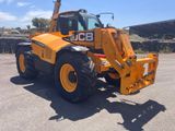 an image of a yellow tractor parked in a parking lot