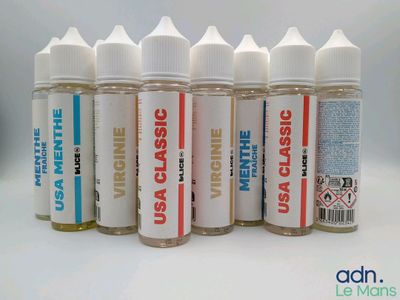 six bottles of various flavored e - liquids lined up on a white surface