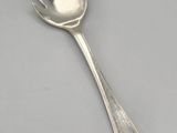 silver spoon with a heart on it sitting on a table