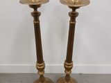 pair of brass candlesticks in the style of person