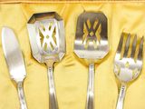 three forks and a knife in a case