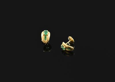 a pair of gold and emerald earrings