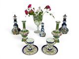 a lot of different vases and cups on the table