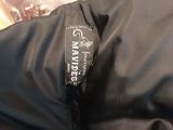 a close up of a black jacket with a logo on it