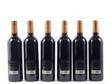 six bottles of wine are lined up on a white surface