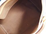 a close up of a purse with a laptop in it