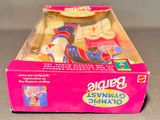 a pink box with a doll in it on a table