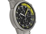 an image of a stainless steel watch with a black face and yellow hands