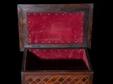 an old wooden chest with a red velvet lining and rivets