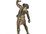 an image of a bronze statue of a man holding a torch