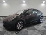 an image of a black tesla vehicle in a showroom