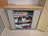 a small cabinet that has a lot of items in it