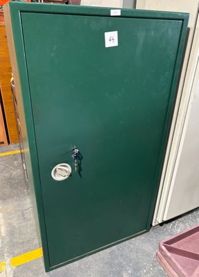 a green door with a lock on it in a warehouse