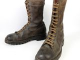 pair of brown leather boots with laces on them on a white background