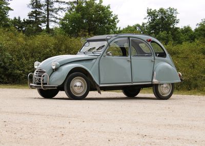a small blue car that is parked in a parking lot