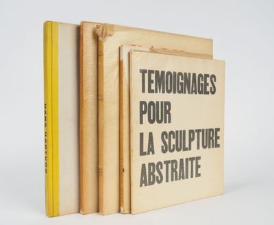 three books stacked on top of each other on a white surface
