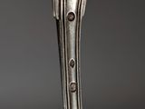 a close up of a spoon with a fork on it