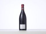 a bottle of red wine sitting on top of a table