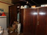 a refrigerator and a refrigerator freezer in a messy room