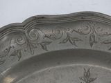 a silver plate with a floral design on it