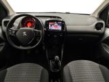 the interior of a small car with a steering wheel and dashboard