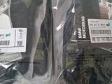 two pairs of shoes that are wrapped in plastic