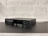 an old stereo player sitting on top of a table in front of a brick wall