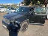 the black jeep is parked in the parking lot next to other cars