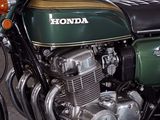 a green and black motorcycle parked in a parking lot