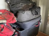 a pile of luggage sitting on top of a cart in a room