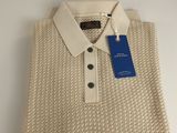 a close up of a white sweater with a blue tag on it