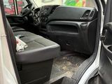 a white van with the door open and a trash can in the back of the van